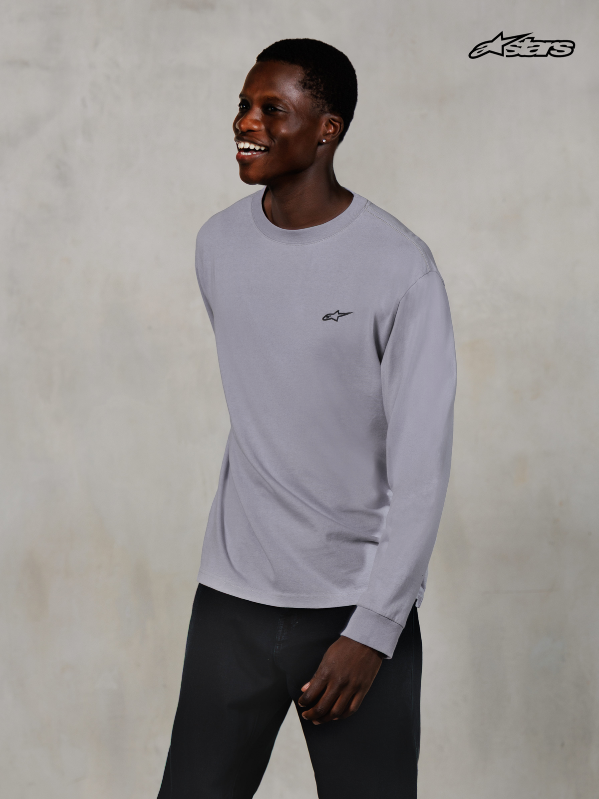 Alpinestars Essentials Ageless T-Shirt, Freizeitmäßiges Langarmshirt in Silber, getragen von einem Model, aus 100% Bio-Baumwolljersey