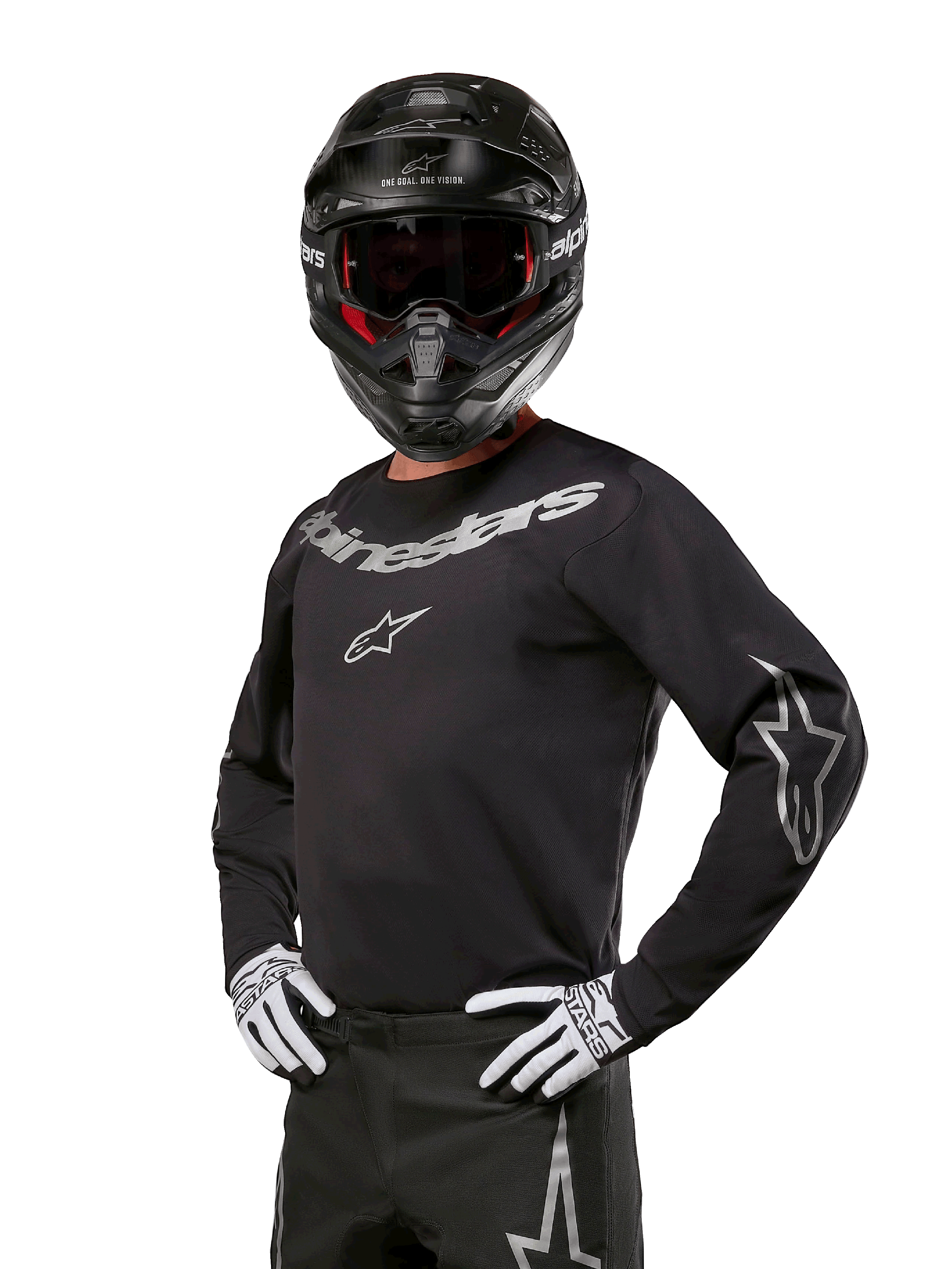Alpinestars 2024 Fluid Graphite Ausrüstungsset, Motocross-Fahrer trägt schwarz-graues Jersey mit markanten grauen Logos, passende Hose, schwarzer Helm und weiß-schwarze Handschuhe, athletische Sportpassform für Offroad-Motocross-Rennen