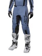 Alpinestars 2024 Fluid Lurv Hose, Motocross-Hose, Hellblau und Schwarz, getragen mit passendem Langarm-Trikot und weißen Motocross-Stiefeln, mit markantem schwarzen Stern-Logo auf dem Oberschenkel und verstärkten Knie-Innenpaneelen, Vorderansicht auf weißem Hintergrund