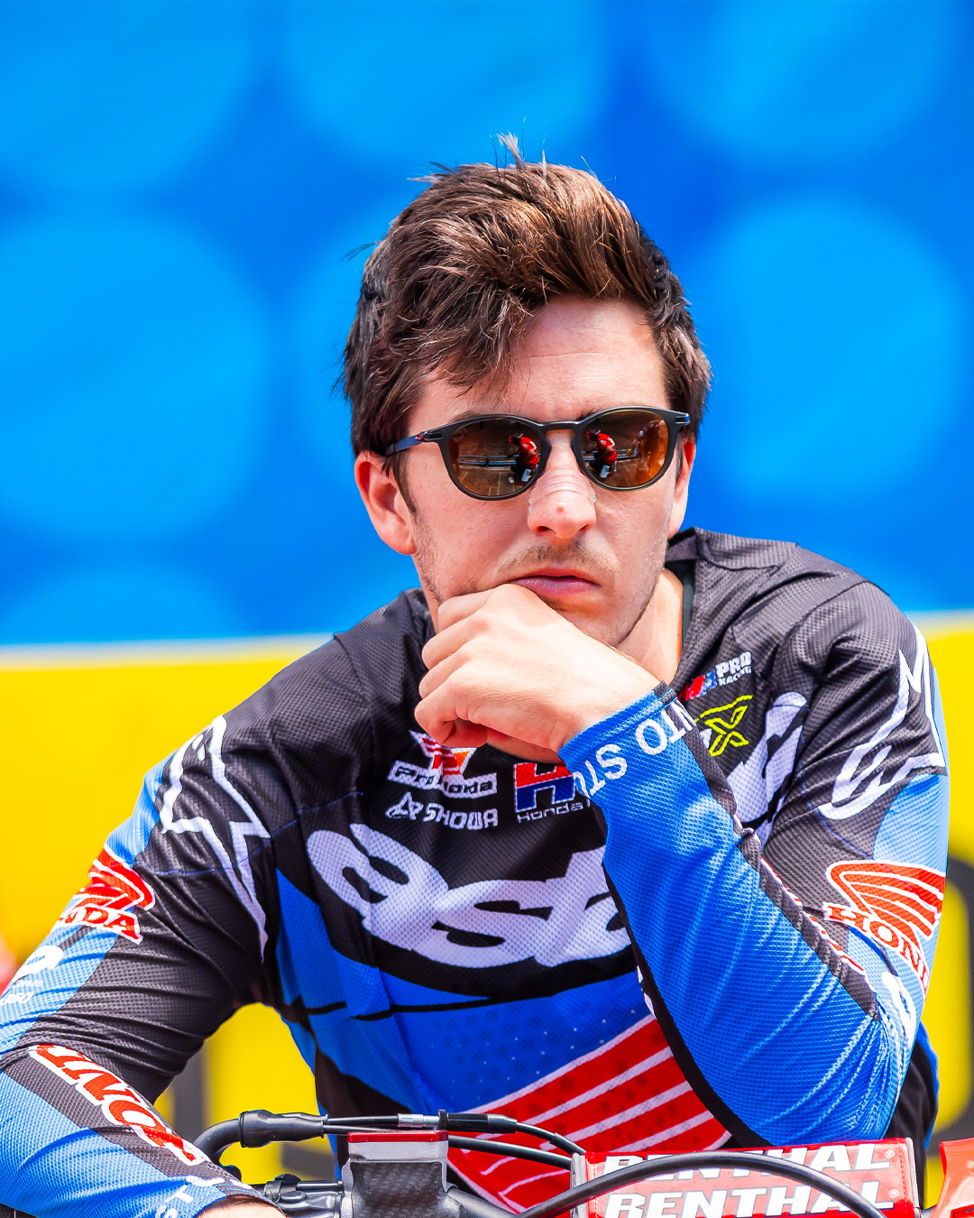 Hunter Lawrence wearing an Alpinestars motocross jersey against a blue and yellow background