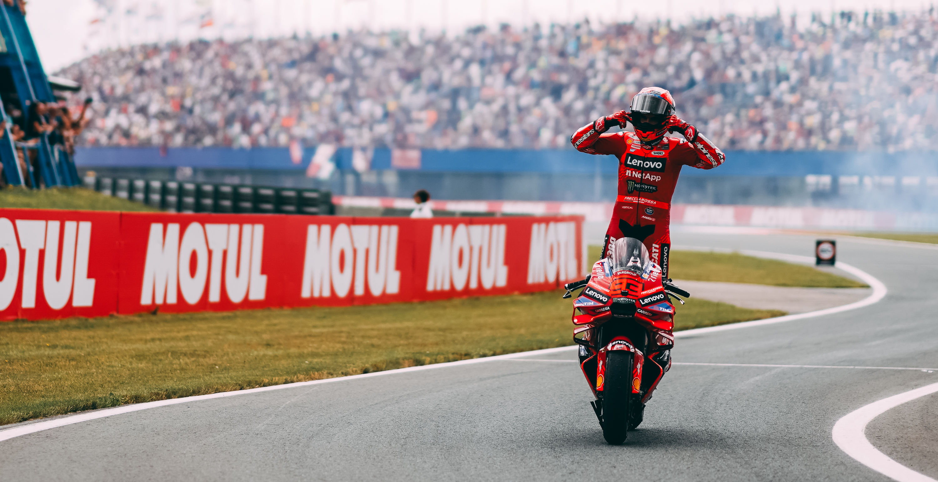 Marc Marquez standing celebrating while riding