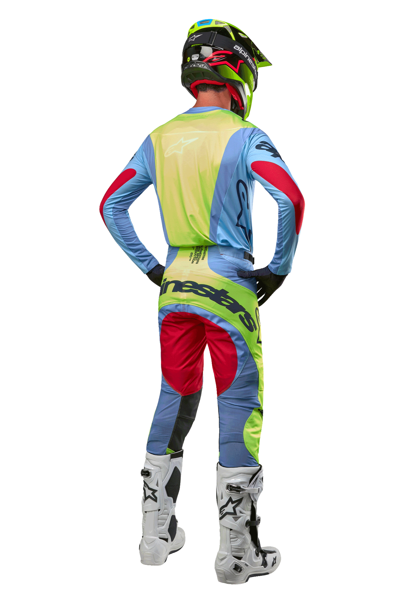 Motocross-Fahrer von hinten mit 2024 Techstar Ocuri Hose und passendem Trikot, Hellblau, Neongelb und Beerenrot, weiß-schwarze Stiefel, schwarzer Helm mit Neon-Akzenten, abgestimmte Alpinestars-Ausrüstung für Offroad-Rennen