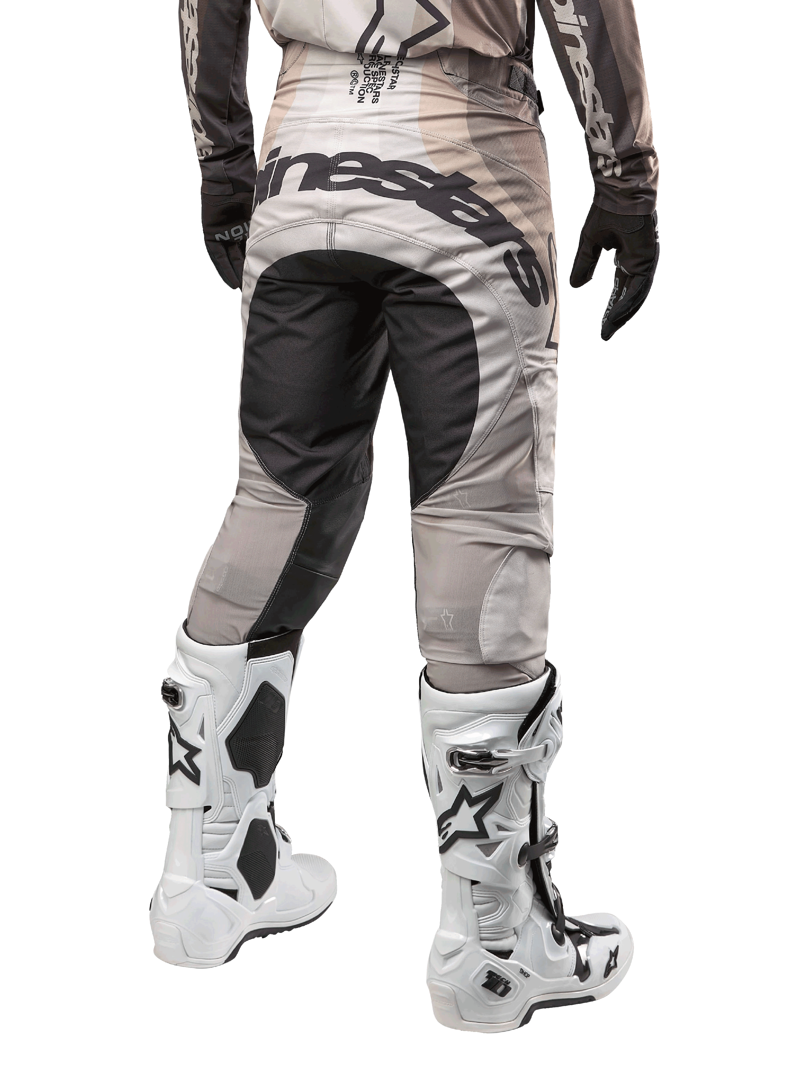Alpinestars 2024 Techstar Pneuma Pants, Motocross Pants, Dark Sand and Iron Dust Gray, rear view from the waist down, bold black Alpinestars branding on the seat, worn with white and black motocross boots and black gloves, durable race-fit design for off-road competition
