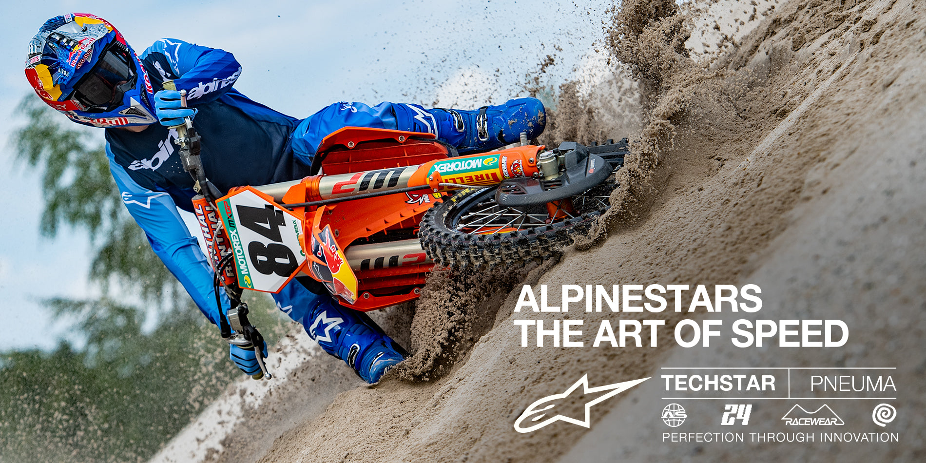 Alpinestars 2024 Techstar Pneuma Jersey and Pants, blue motocross gear set, professional rider carving through sand.