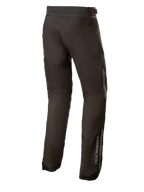 Alpinestars AST-1 V2 Waterproof Pants Long, Black textile motorcycle pants, rear view showing reflective detailing and vertical branding on the lower leg, durable all-weather riding gear