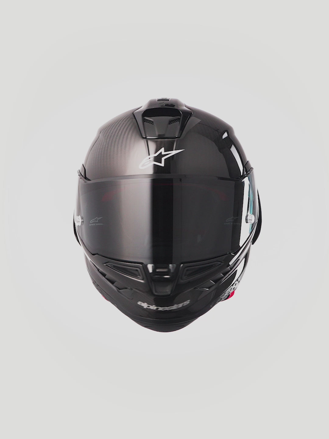 Alpinestars Supertech R10 Solid Helmet, Black Carbon motorcycle racing helmet featuring an aerodynamic carbon fiber shell, tinted visor, and certified track protection